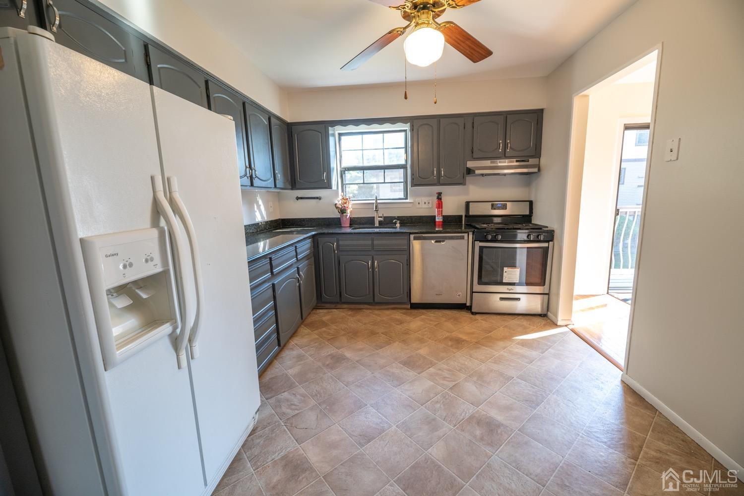 7101 Hana Road Edison, NJ 08817 - Photo 27 of 77 a kitchen with stainless steel appliances granite countertop a refrigerator a sink a stove a microwave and island