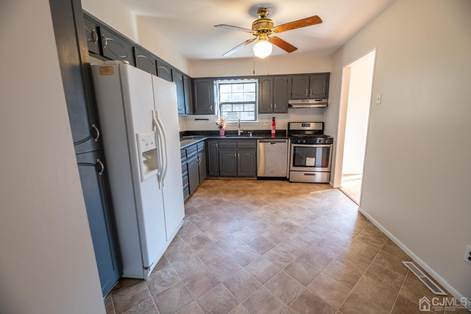 7101 Hana Road Edison, NJ 08817 - Photo 28 of 77 a kitchen with stainless steel appliances a refrigerator a stove a sink a window and a refrigerator