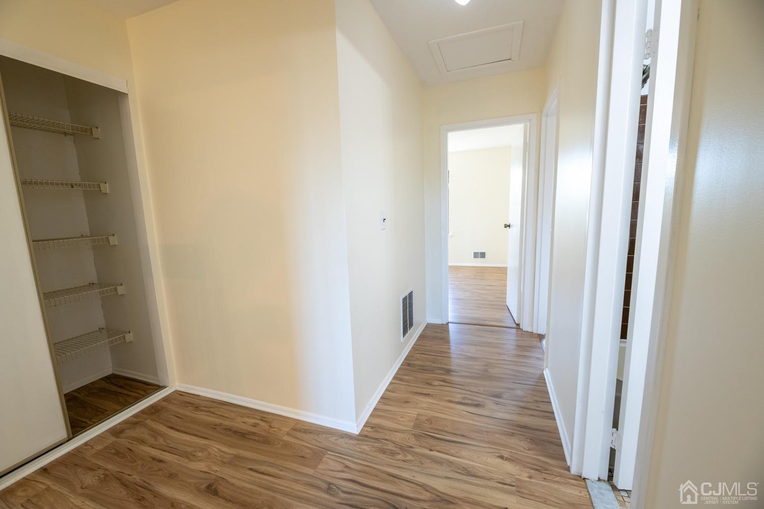 7101 Hana Road Edison, NJ 08817 - Photo 42 of 77 a view of a hallway with wooden floor