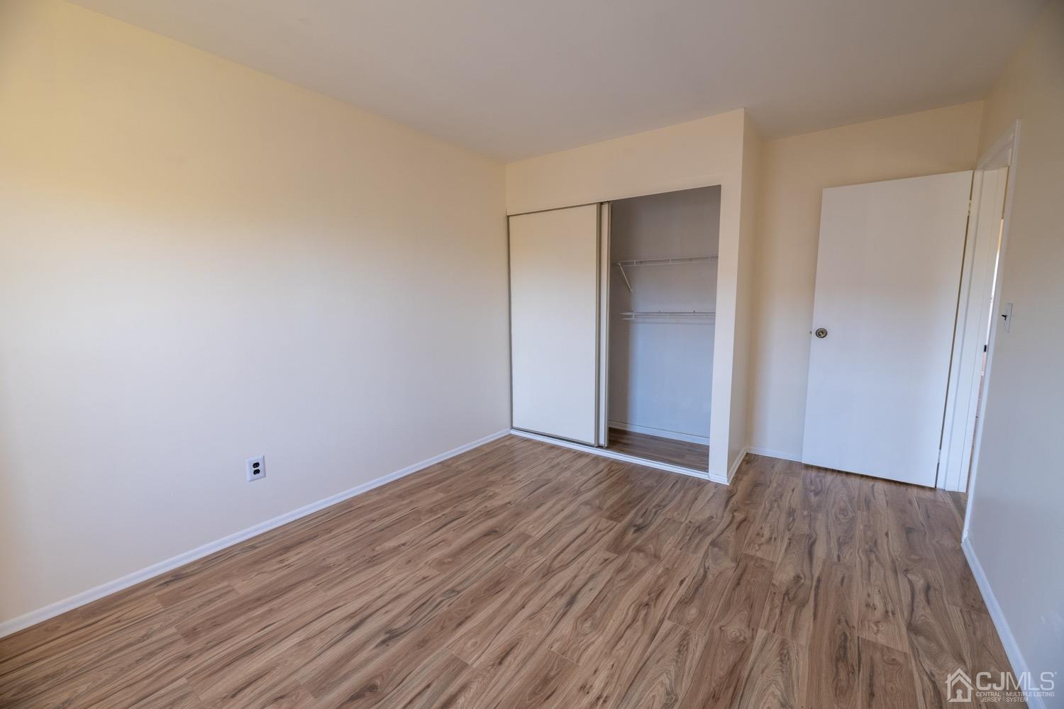 7101 Hana Road Edison, NJ 08817 - Photo 54 of 77 a view of an empty room with wooden floor
