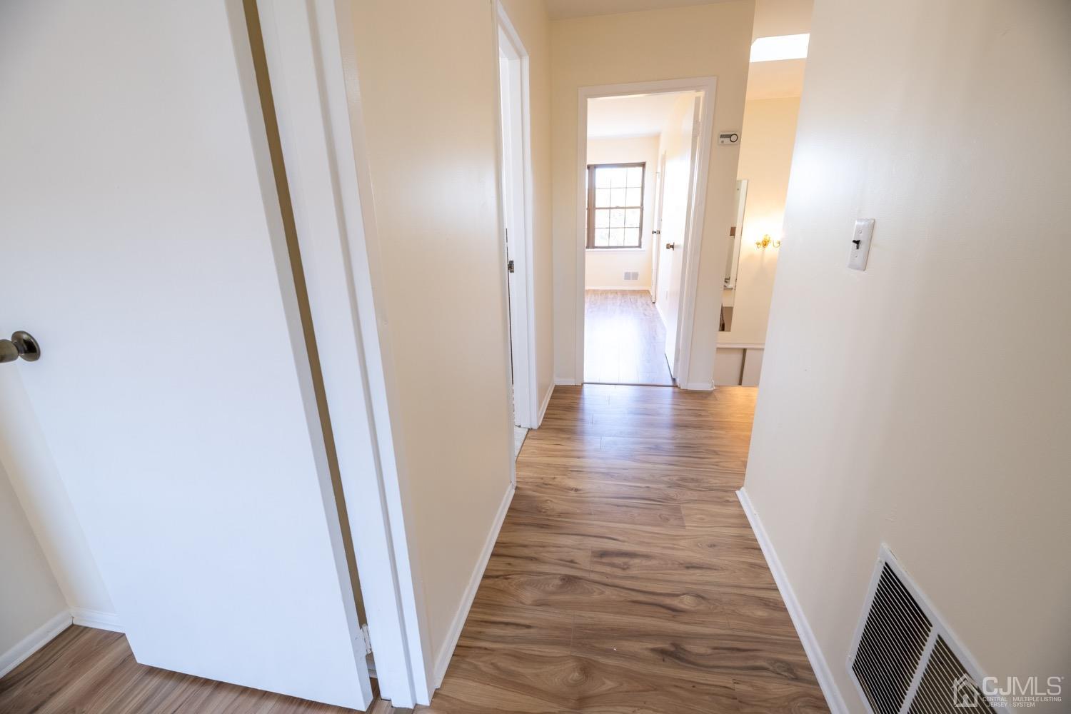 7101 Hana Road Edison, NJ 08817 - Photo 57 of 77 a view of a hallway with wooden floor