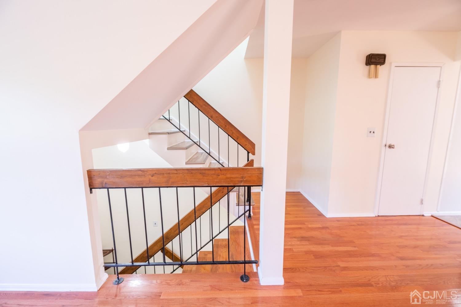 7101 Hana Road Edison, NJ 08817 - Photo 6 of 77 a view of staircase with white walls and a window