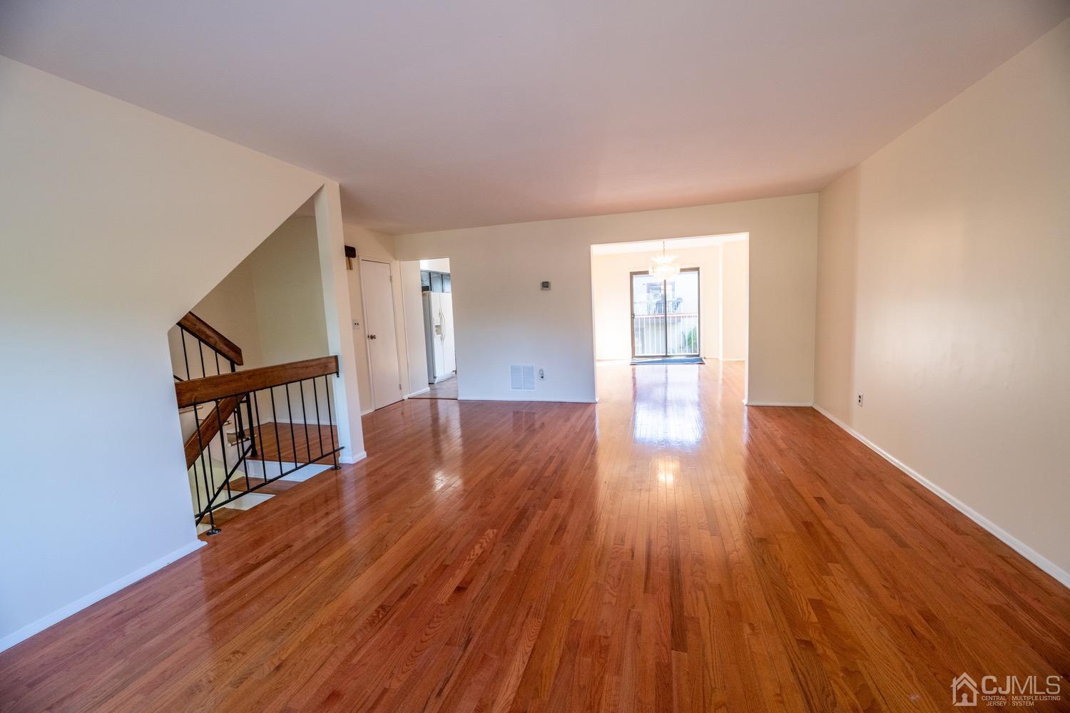 7101 Hana Road Edison, NJ 08817 - Photo 10 of 77 a view of a big room with wooden floor and windows