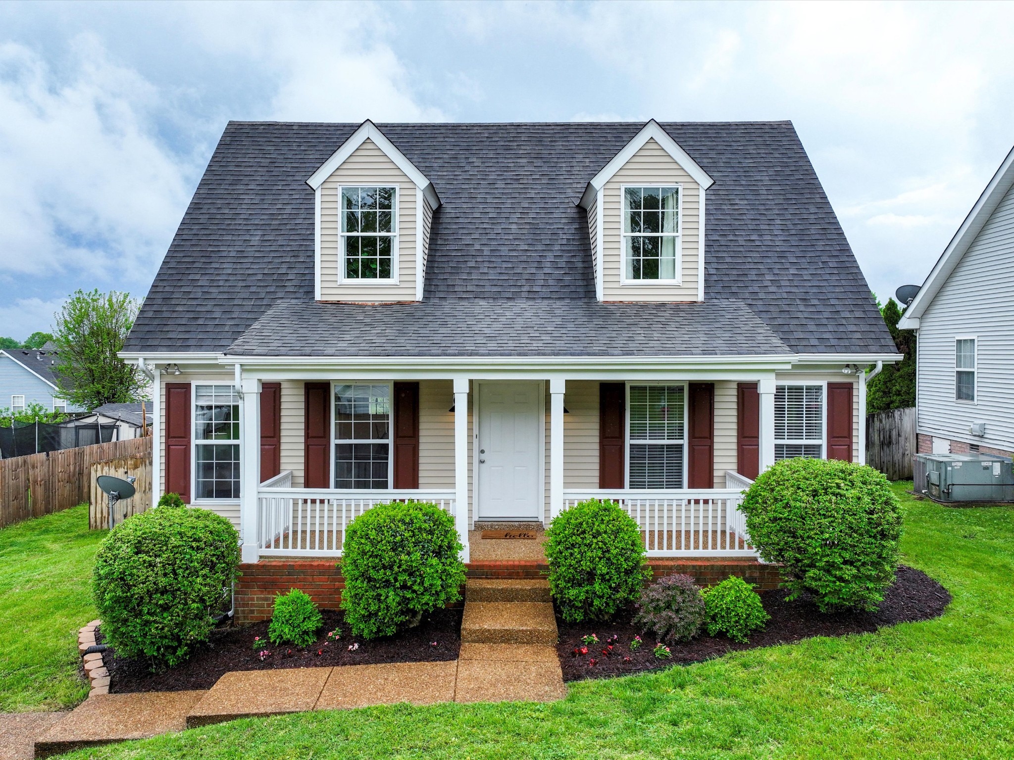 front view of brick house with a yard
