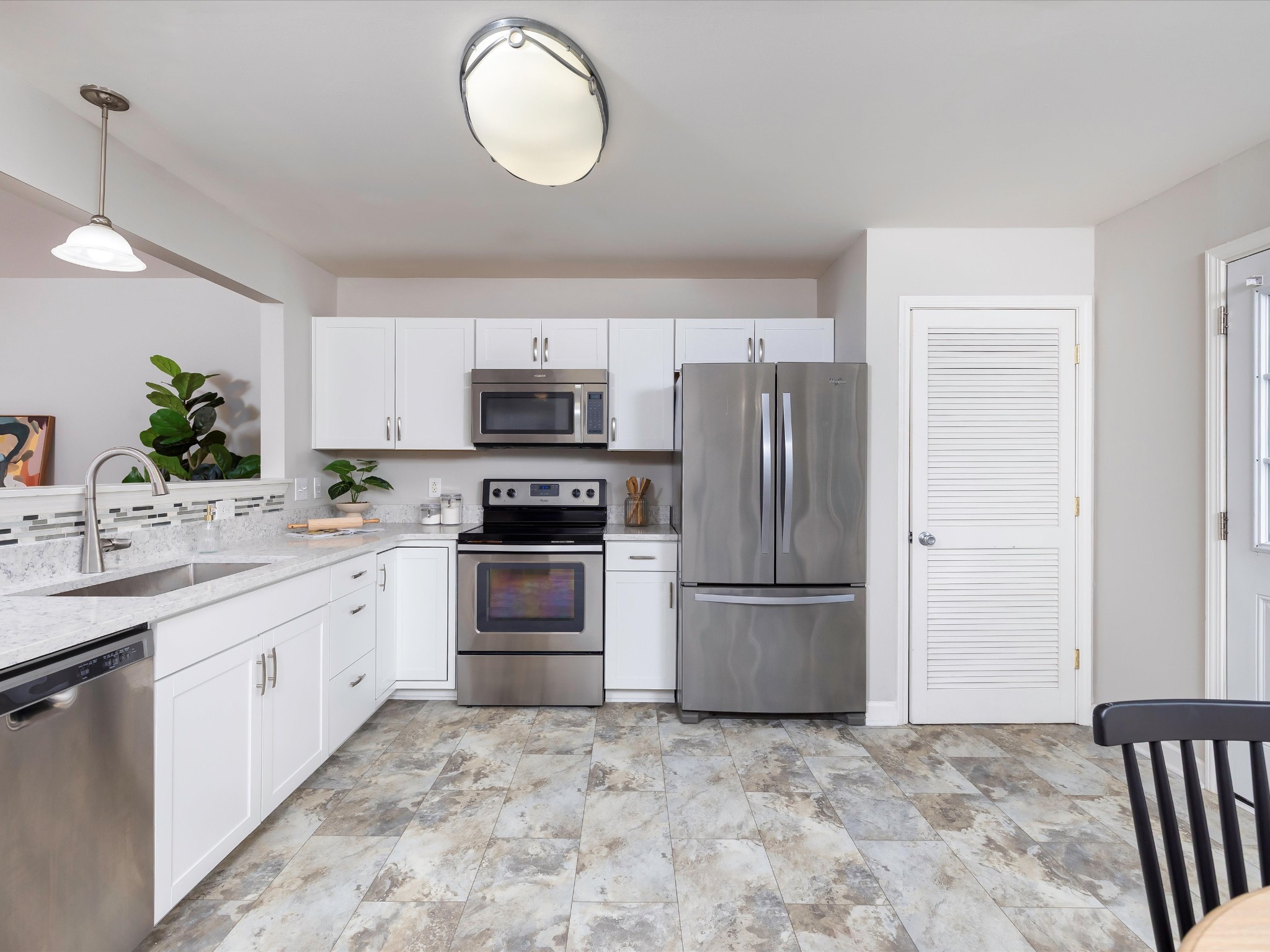 1007 Persimmon Drive Spring Hill, TN 37174 - Photo 15 of 44 a kitchen with a sink stainless steel appliances and cabinets