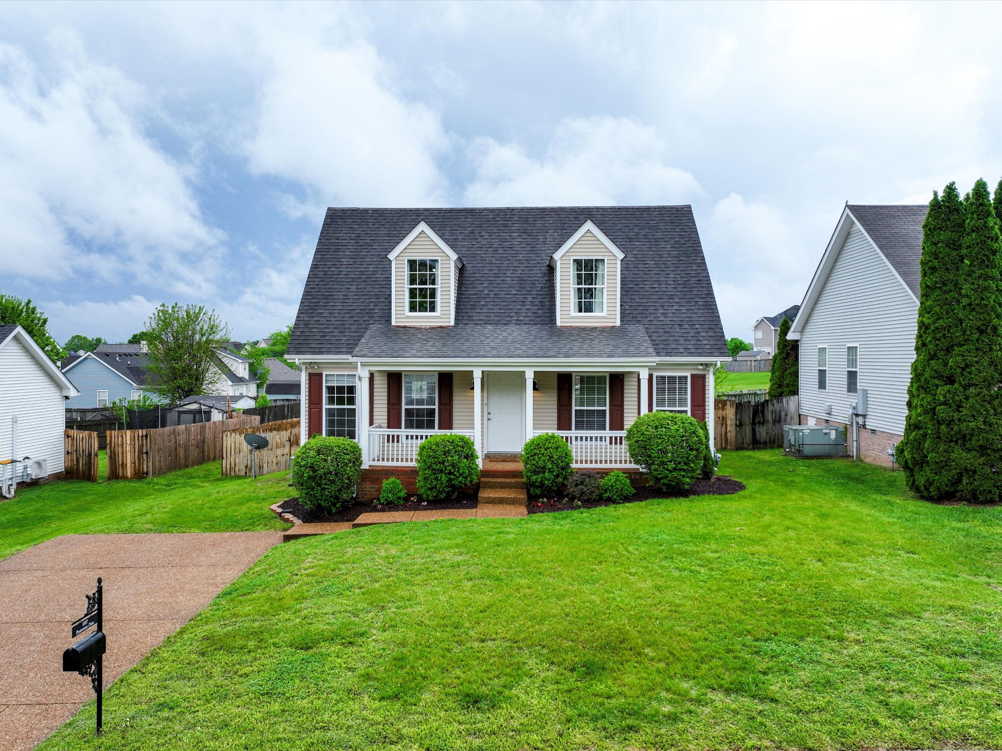 1007 Persimmon Drive Spring Hill, TN 37174 - Photo 3 of 44 a front view of a house with garden and trees