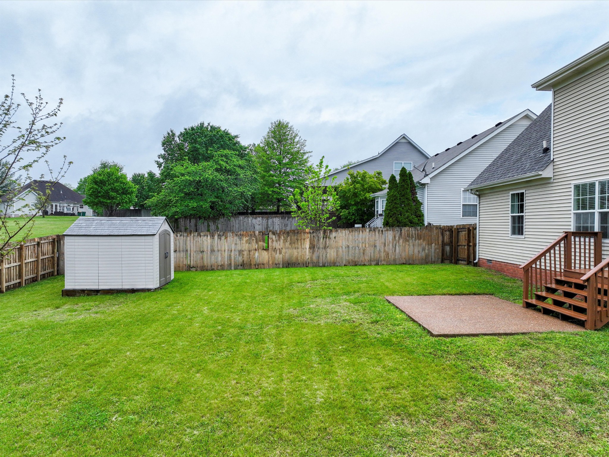 1007 Persimmon Drive Spring Hill, TN 37174 - Photo 37 of 44 a view of a house with backyard and a garden