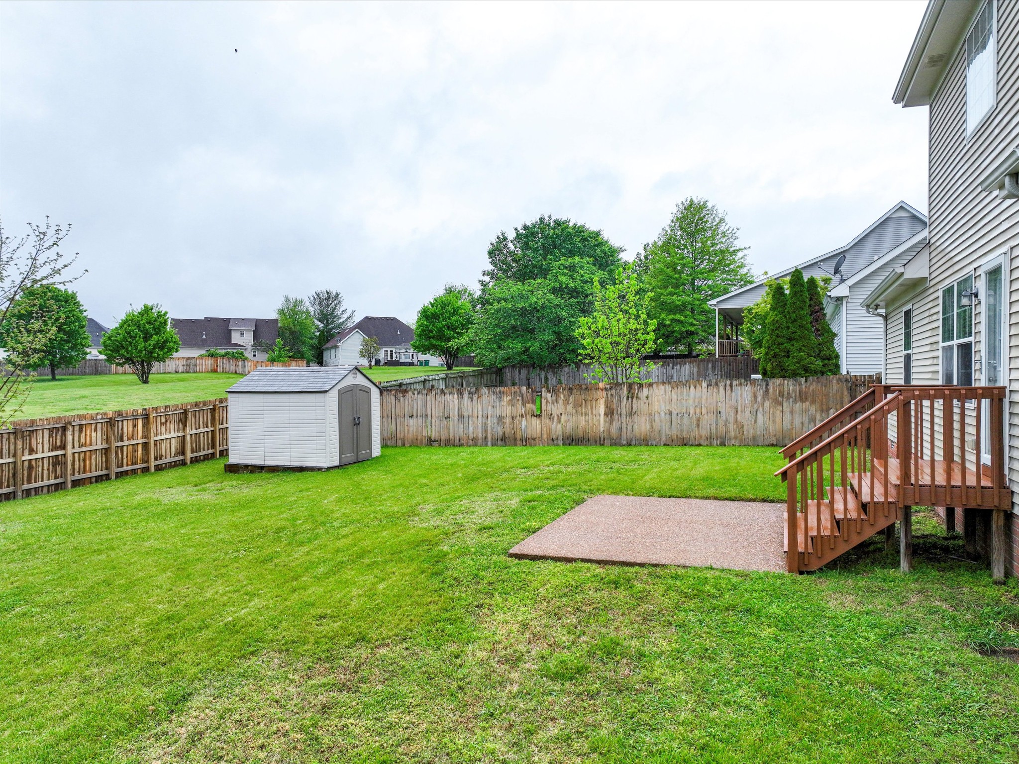 1007 Persimmon Drive Spring Hill, TN 37174 - Photo 38 of 44 a view of a deck with a big yard potted plants and large tree
