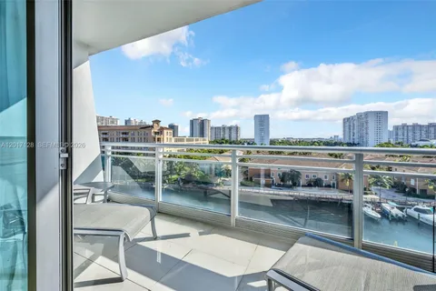 a view of a balcony with two chairs and a table