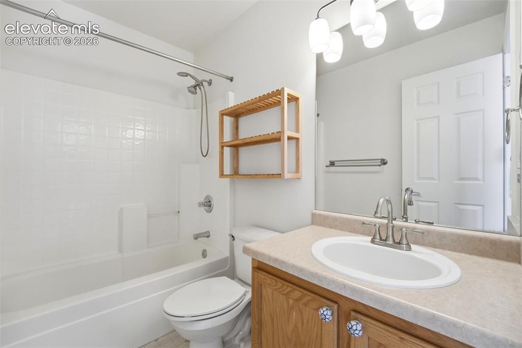 7904 Coffee Road Peyton, CO 80831 - Photo 19 of 48 Bathroom with white subway tile shower surround, chrome shower fixtures, and a white bathtub