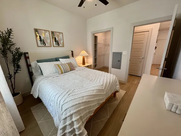a bedroom with a bed and a couch