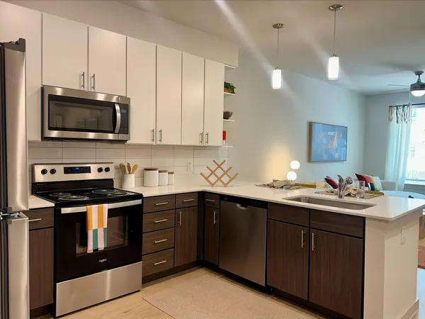 a kitchen with a sink stove and microwave