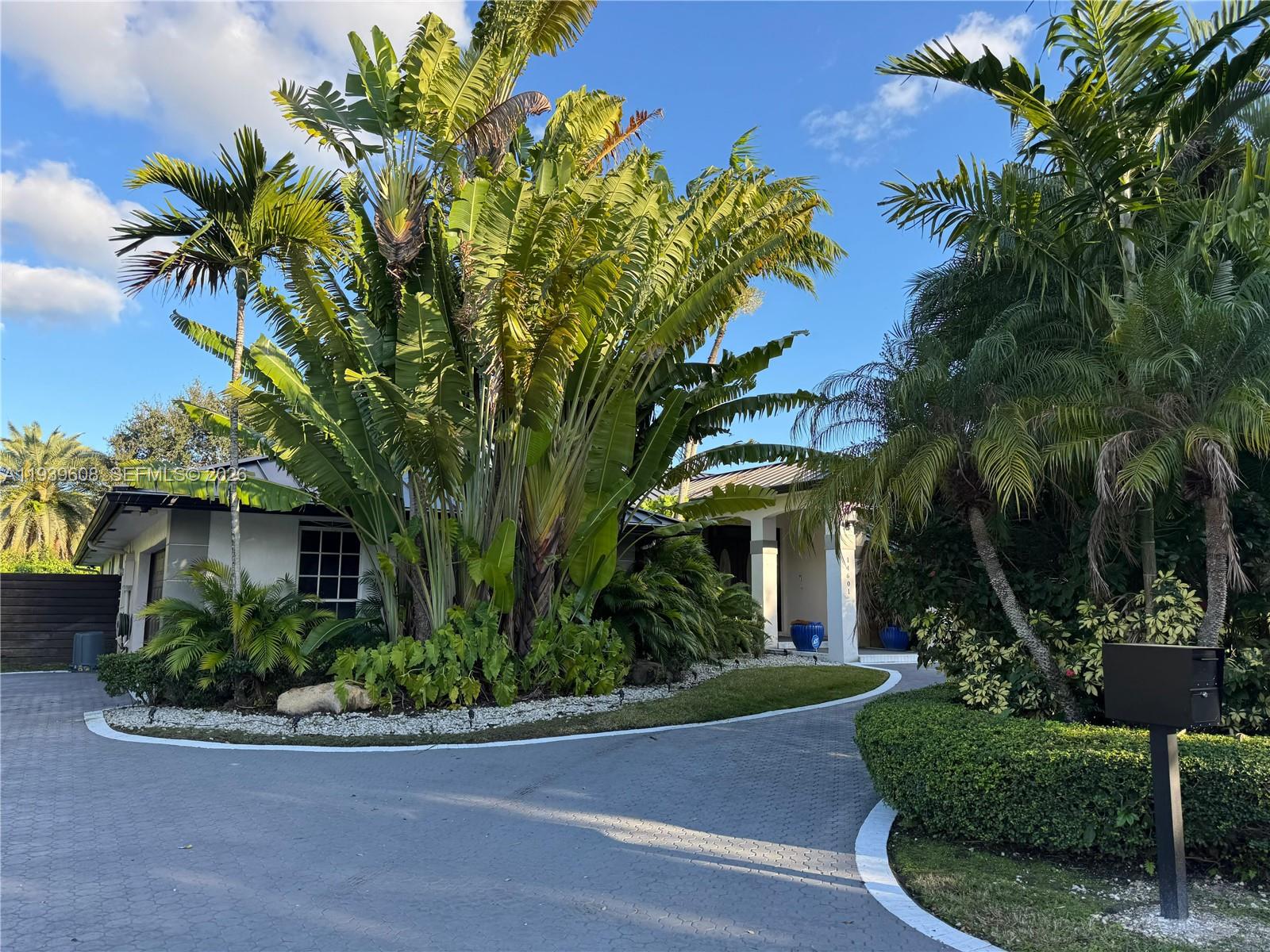 14601 Southwest 99th Avenue Miami, FL 33176 - Photo 1 of 19 a front view of a house with plants