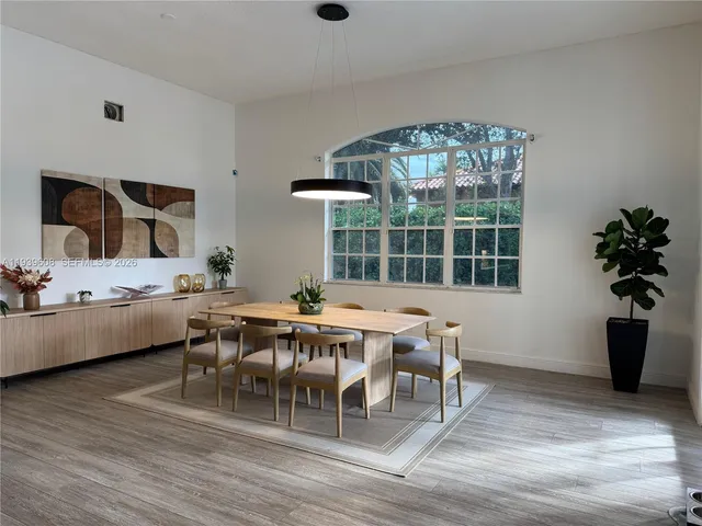 a view of a dining room with furniture window and wooden floor