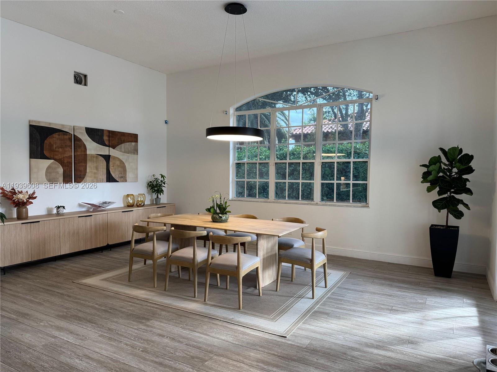 14601 Southwest 99th Avenue Miami, FL 33176 - Photo 11 of 19 a view of a dining room with furniture window and wooden floor