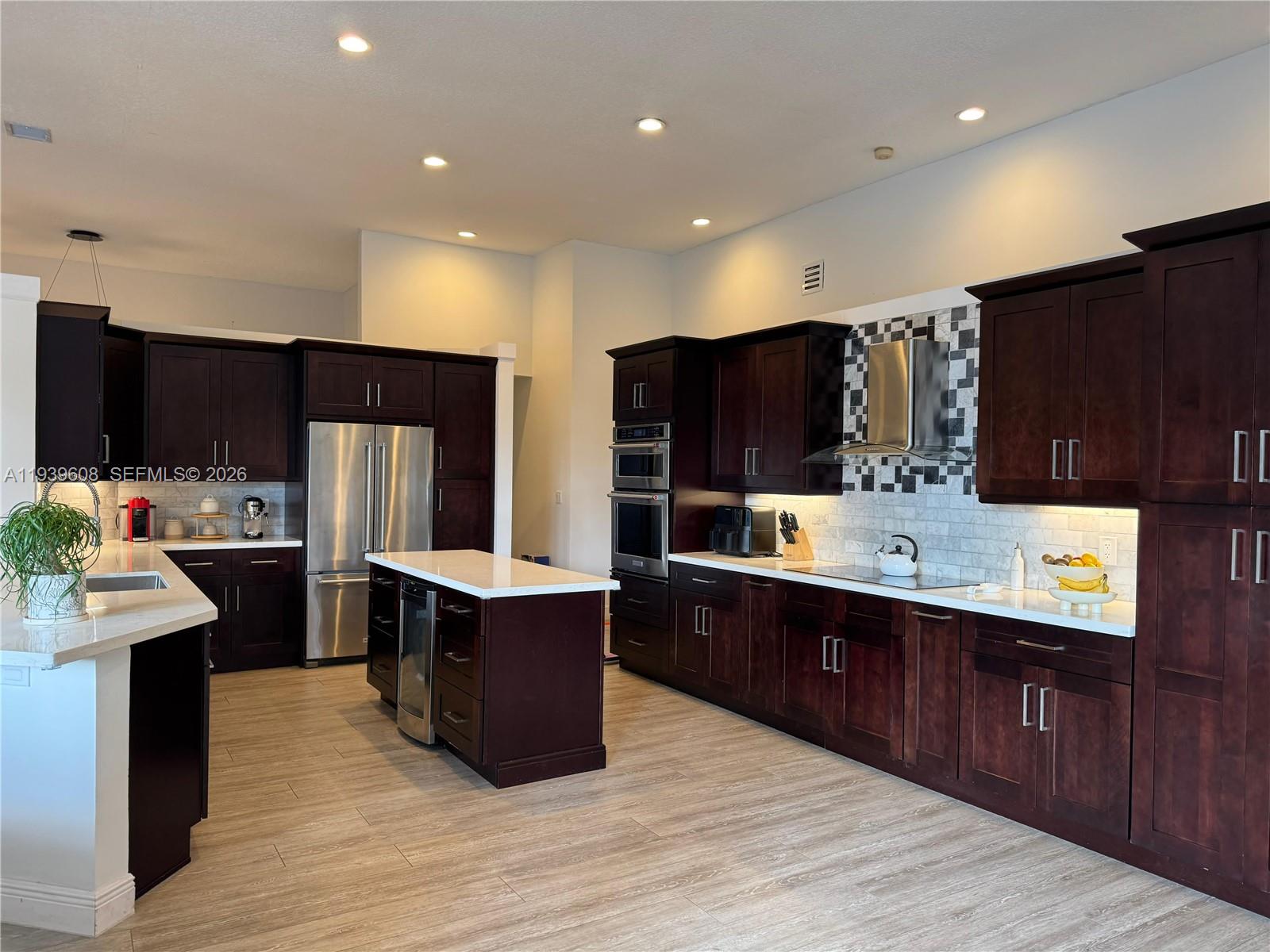 14601 Southwest 99th Avenue Miami, FL 33176 - Photo 12 of 19 a kitchen with stainless steel appliances kitchen island granite countertop wood cabinets and refrigerator