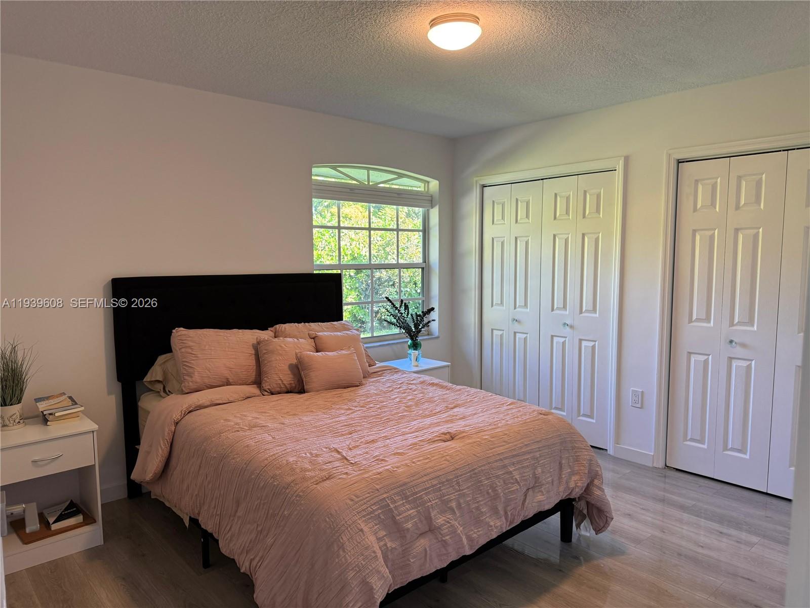 14601 Southwest 99th Avenue Miami, FL 33176 - Photo 15 of 19 a bed sitting in a bedroom next to a window