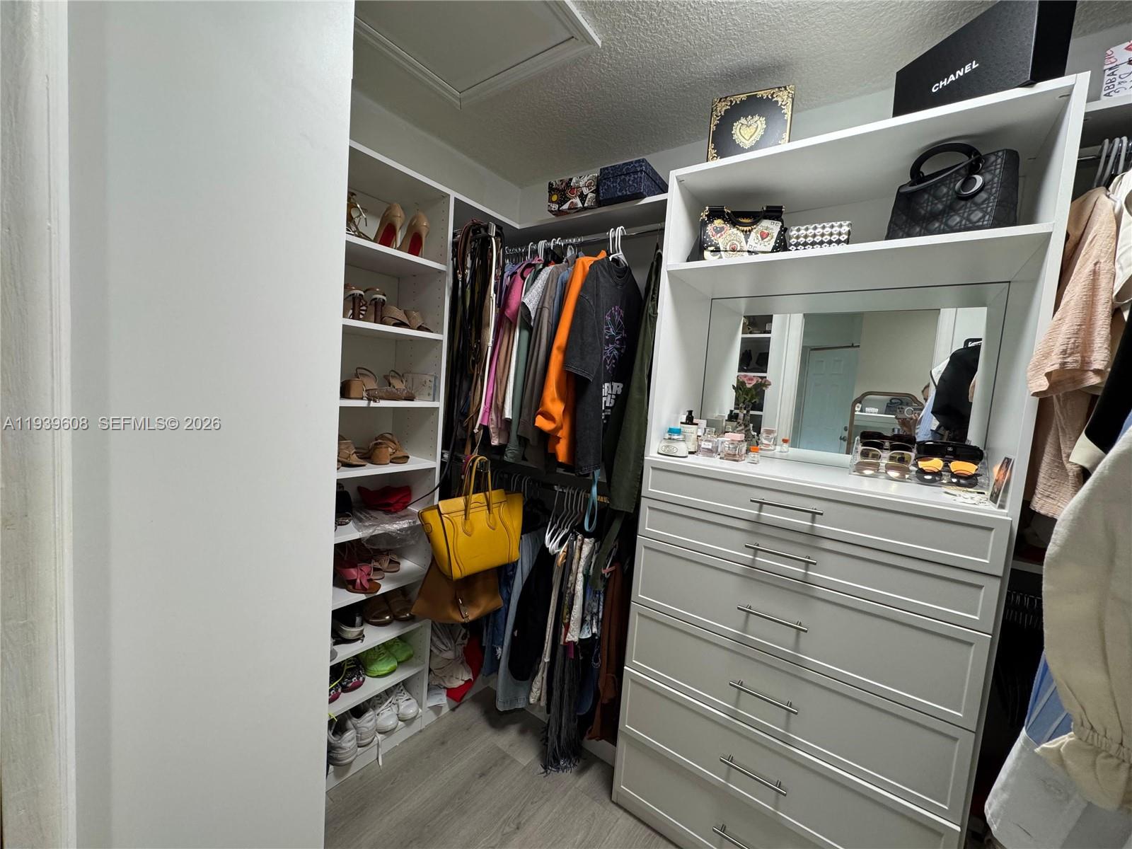 14601 Southwest 99th Avenue Miami, FL 33176 - Photo 17 of 19 a view of walk in closet with clothes and shoes
