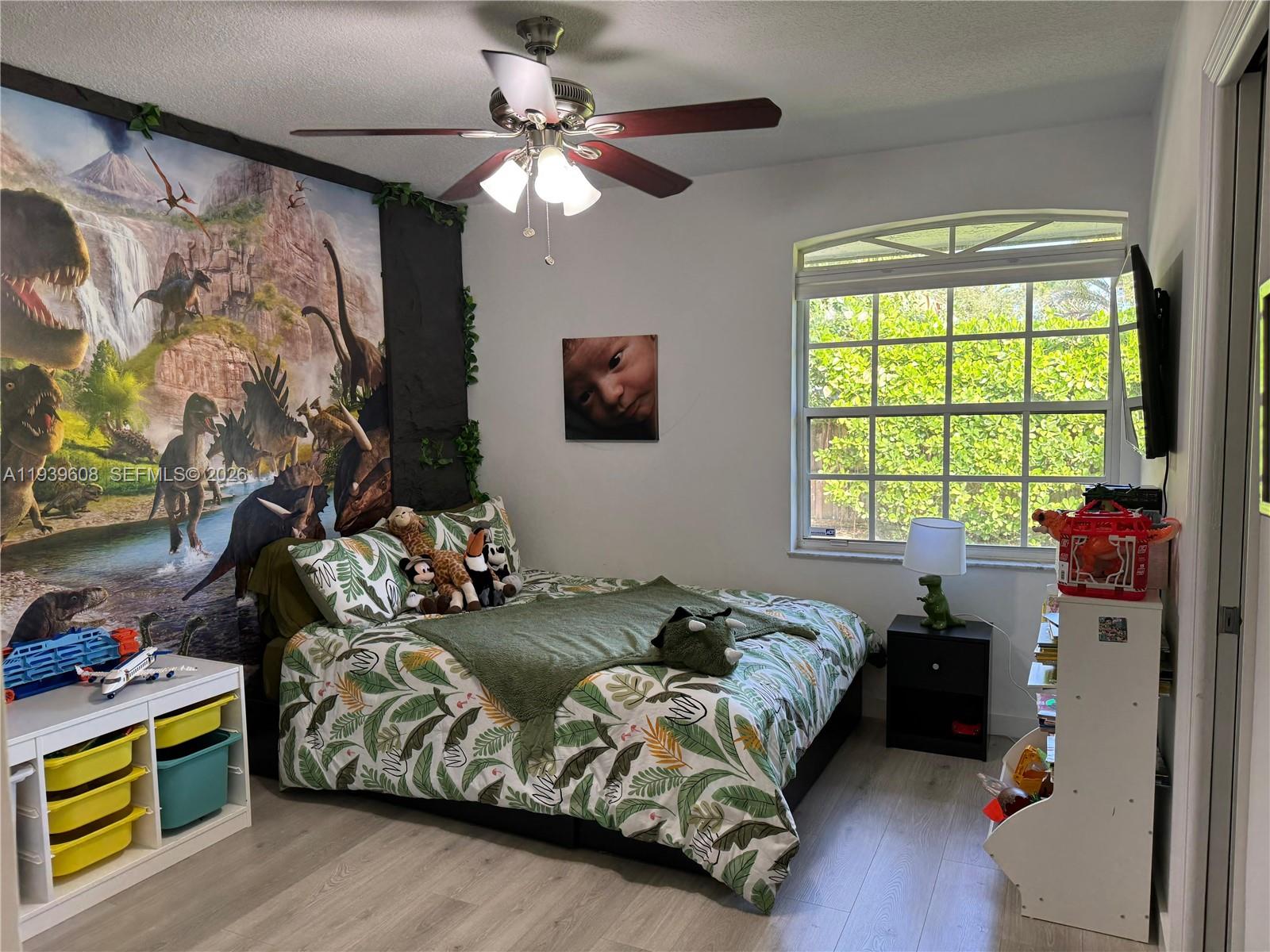 14601 Southwest 99th Avenue Miami, FL 33176 - Photo 18 of 19 a bedroom with bed and window