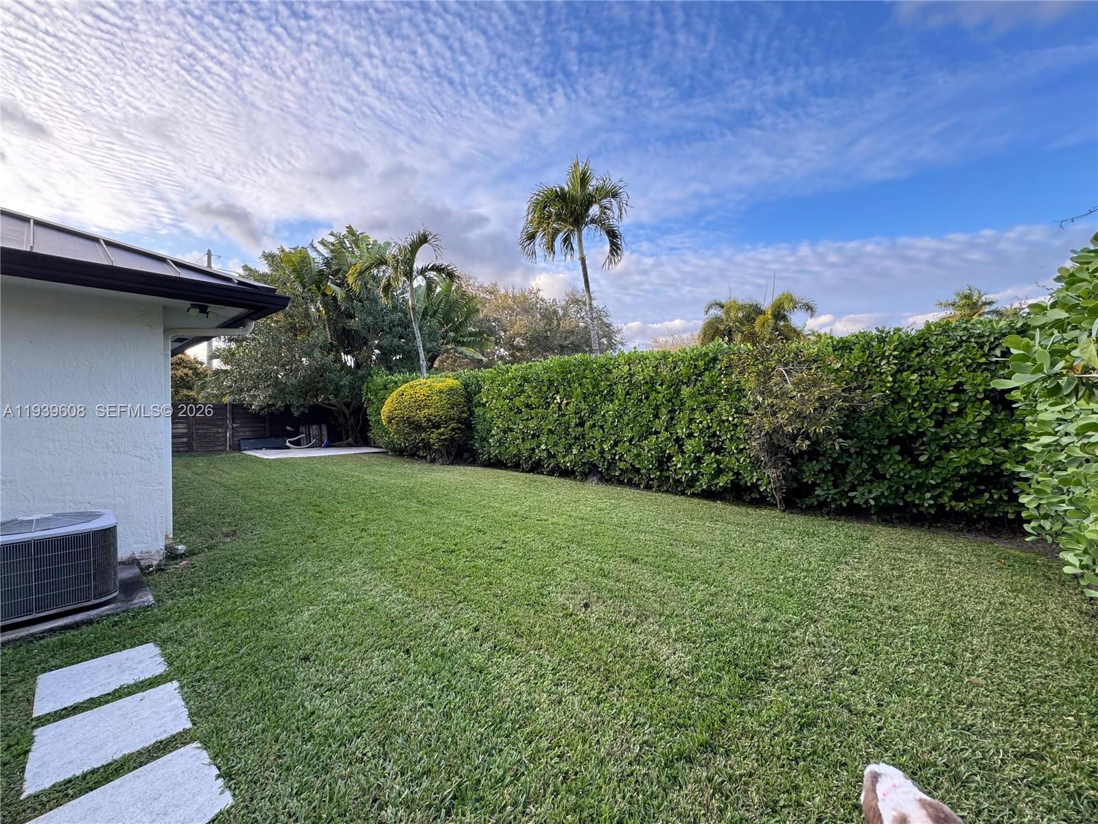 14601 Southwest 99th Avenue Miami, FL 33176 - Photo 8 of 19 a view of a garden with a bench
