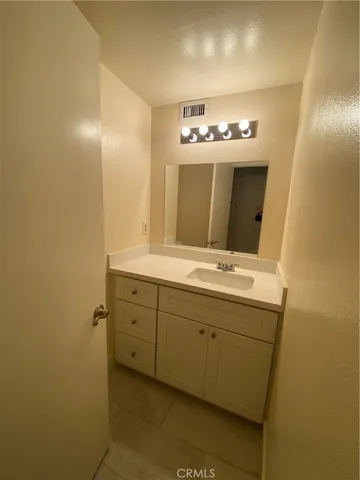 a bathroom with a double vanity sink and a mirror