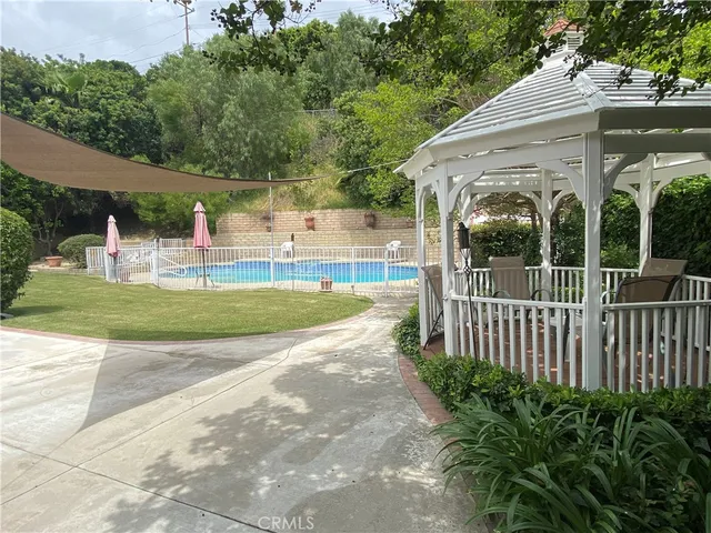 a view of a house with backyard and porch