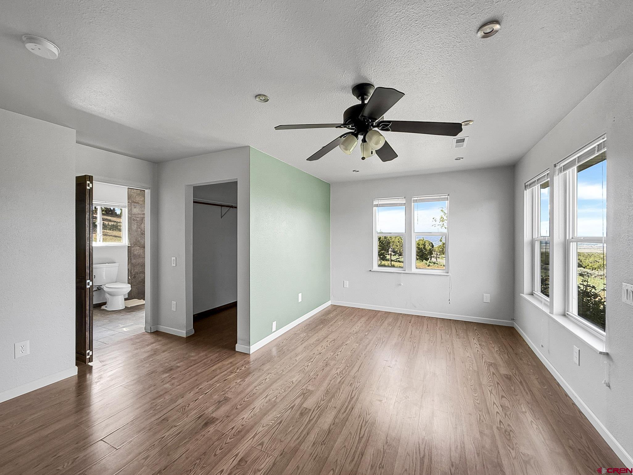 32310 B50 Road Crawford, CO 81415 - Photo 17 of 45 a view of an empty room with wooden floor and a window