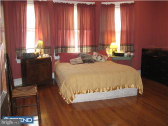 9 Chelten Road Havertown, PA 19083 - Photo 10 of 12 a large bed sitting in a bedroom next to a window