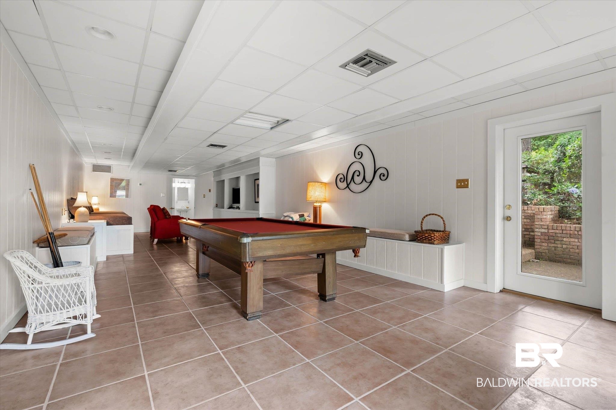 3500 Venetia Road Mobile, AL 36605 - Photo 32 of 56 Spacious lower-level room featuring tiled flooring, a built-in bench, and white paneled walls