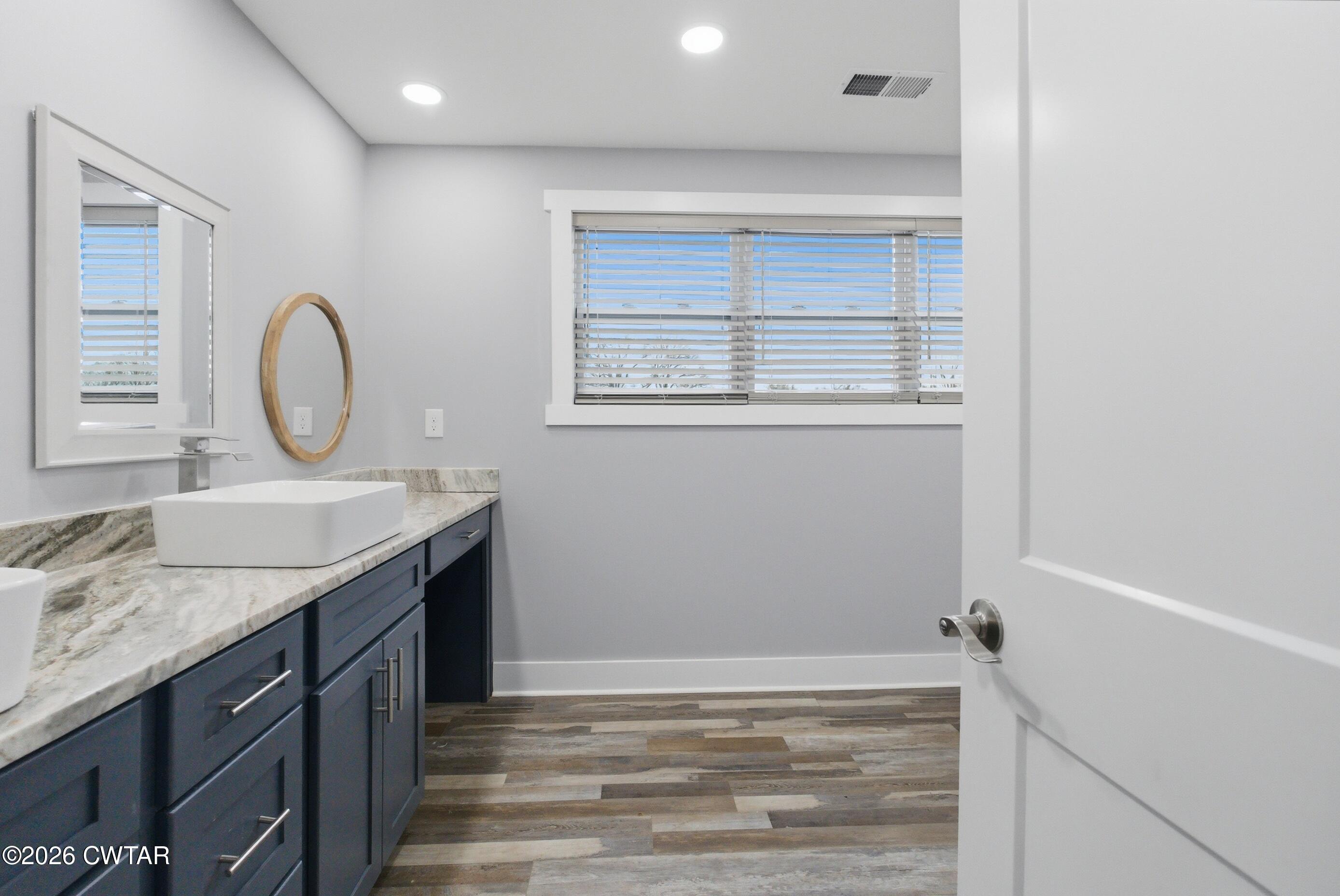 1586 Love Road Bells, TN 38006 - Photo 28 of 61 a bathroom with a granite countertop sink and a mirror