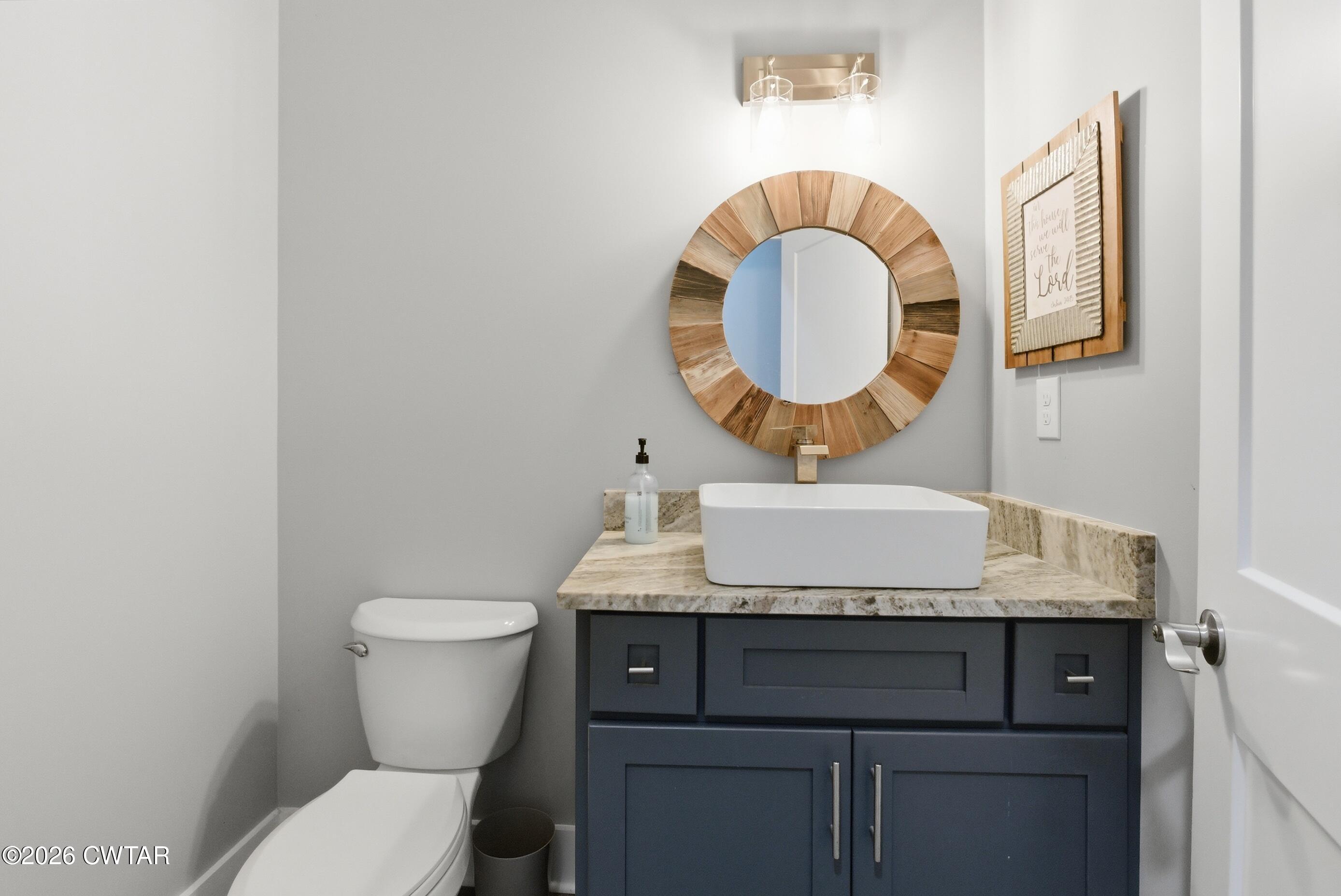 1586 Love Road Bells, TN 38006 - Photo 32 of 61 a bathroom with a toilet a sink and a mirror