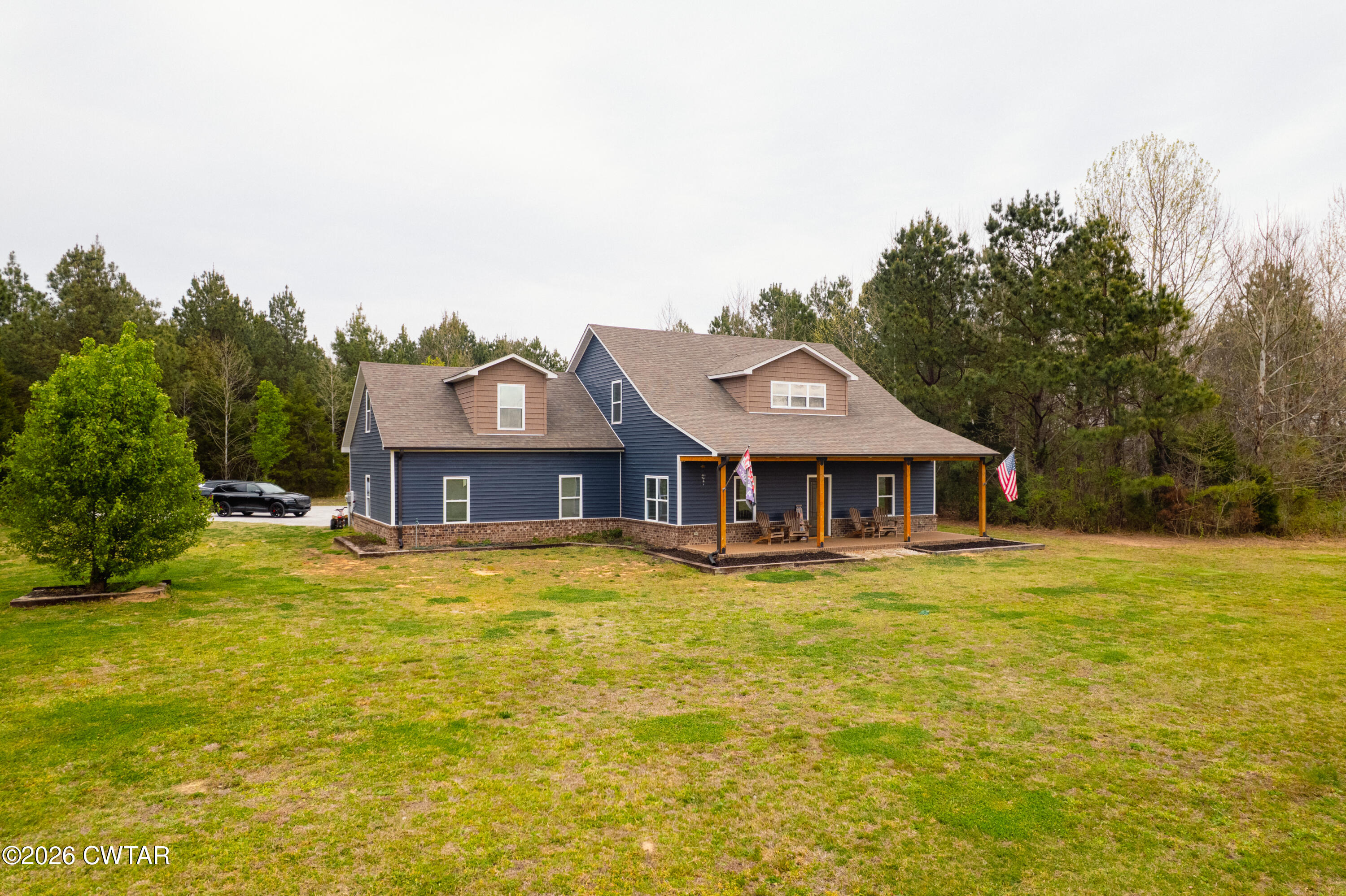 1586 Love Road Bells, TN 38006 - Photo 40 of 61 a house that is sitting in front of a house with a yard and garage