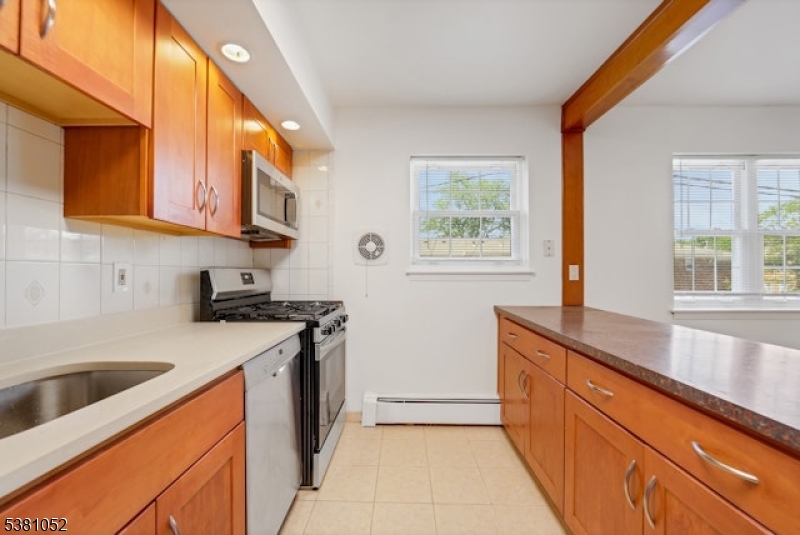 1285 Valley Road Wayne, NJ 07470 - Photo 13 of 33 a kitchen with stainless steel appliances granite countertop a sink and a stove