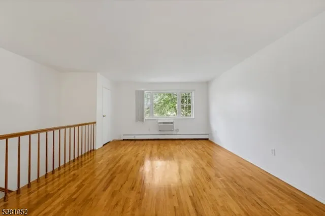 a view of a room with wooden floor and window