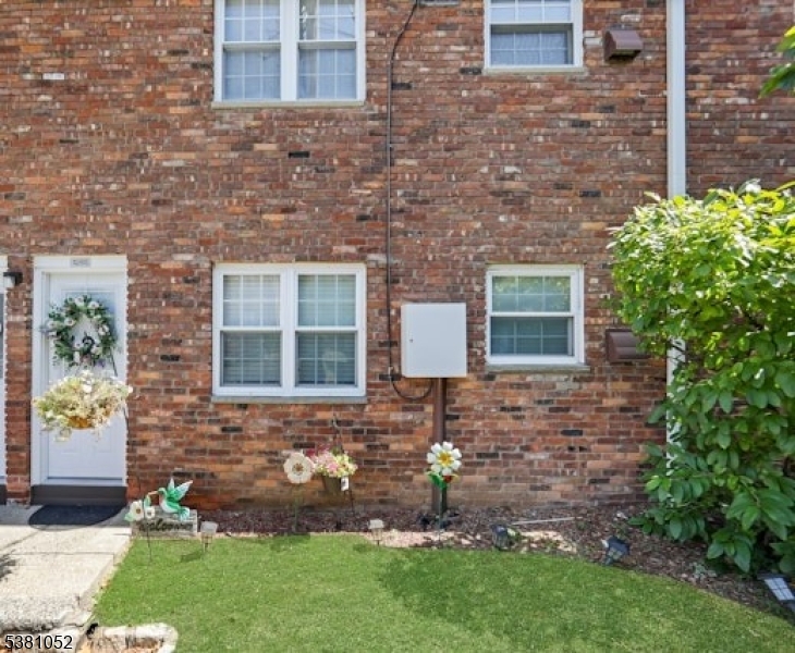 1285 Valley Road Wayne, NJ 07470 - Photo 30 of 33 a brick building with a yard and a garden