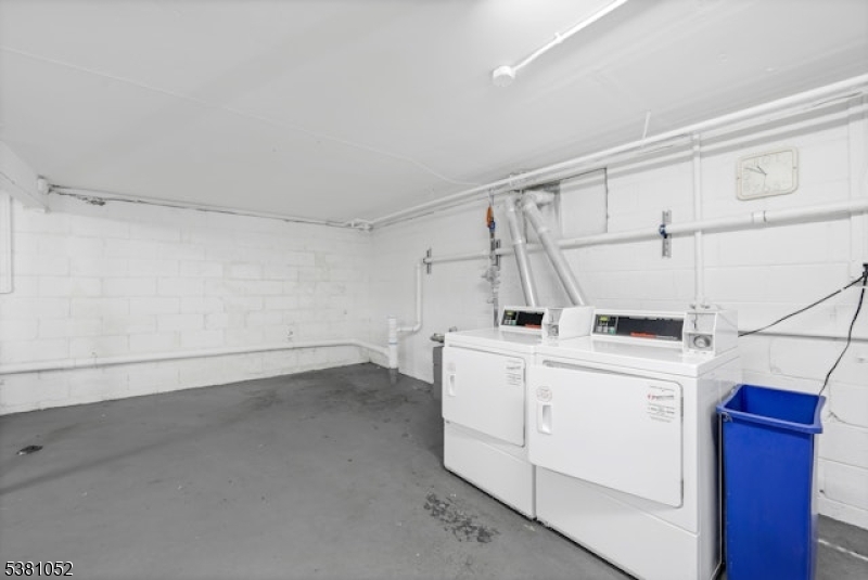1285 Valley Road Wayne, NJ 07470 - Photo 32 of 33 a view of a storage & utility room with dryer and washer