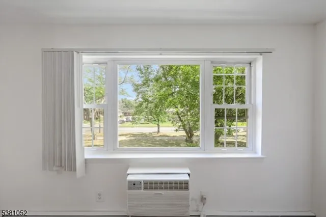a living room view with a large window and kitchen view