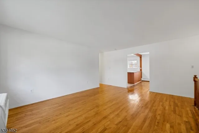 a view of an empty room and wooden floor