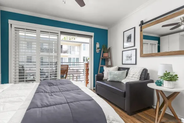 a bedroom with a large bed and a couch