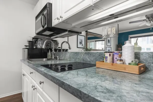 a kitchen with kitchen island a sink and a stove