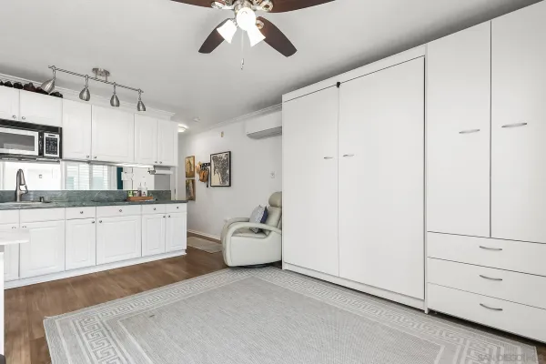 a large white kitchen with cabinets