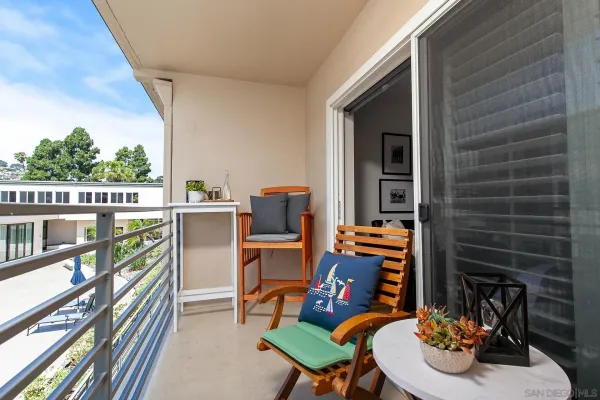 a balcony with table and chairs