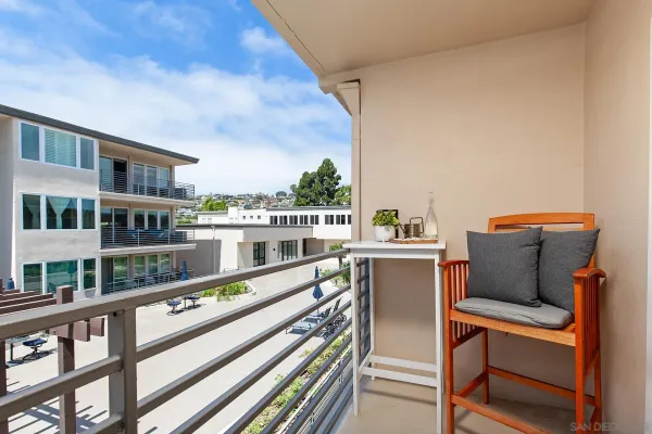 a balcony with table and chairs