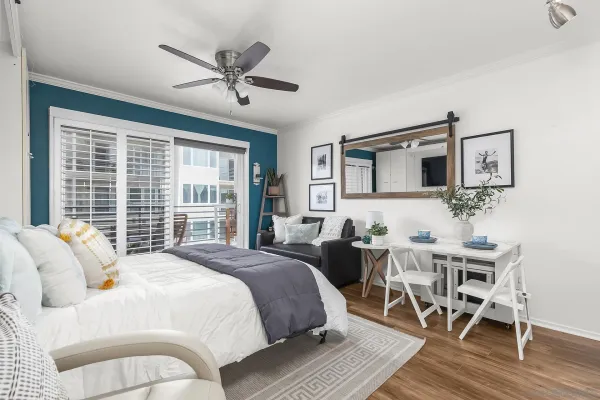 a bedroom with a bed and wooden floor