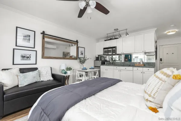 a bedroom with a bed and ceiling fan