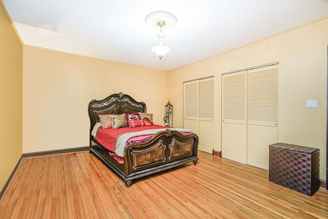 8701 Shore Road, Unit 421 Brooklyn, NY 11209 - Photo 13 of 20 a bedroom with a bed and wooden floor