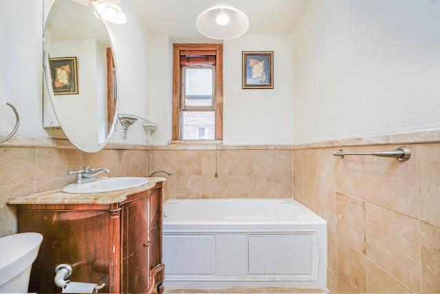 8701 Shore Road, Unit 421 Brooklyn, NY 11209 - Photo 15 of 20 a bathroom with a sink and a mirror
