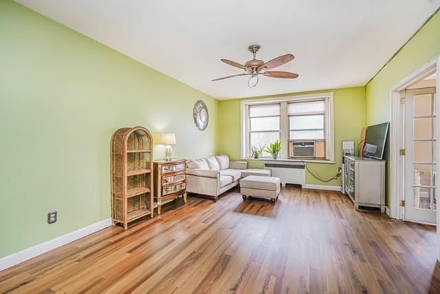 8701 Shore Road, Unit 421 Brooklyn, NY 11209 - Photo 3 of 20 a living room with furniture a fireplace and a window