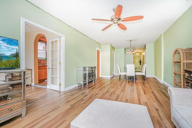 8701 Shore Road, Unit 421 Brooklyn, NY 11209 - Photo 4 of 20 a living room with furniture floor to ceiling window and wooden floor