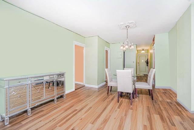 8701 Shore Road, Unit 421 Brooklyn, NY 11209 - Photo 5 of 20 a view of a dining room with furniture window and wooden floor